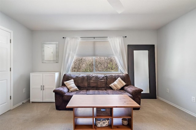 living room with baseboards and light carpet