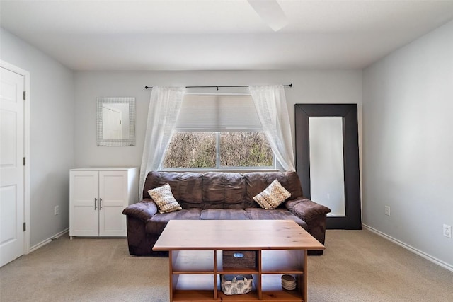 living room featuring light carpet and baseboards