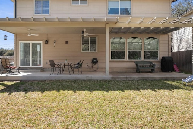 back of property featuring a yard, fence, ceiling fan, and a patio area