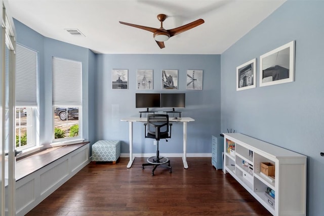 home office featuring dark wood-type flooring, baseboards, visible vents, and ceiling fan