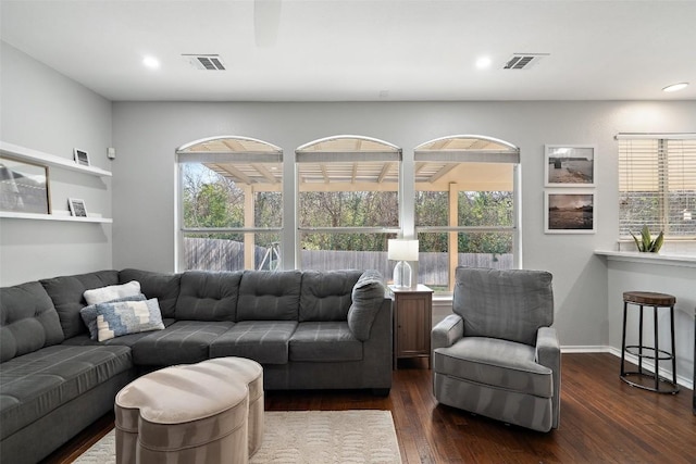 living room with dark wood-style flooring and recessed lighting