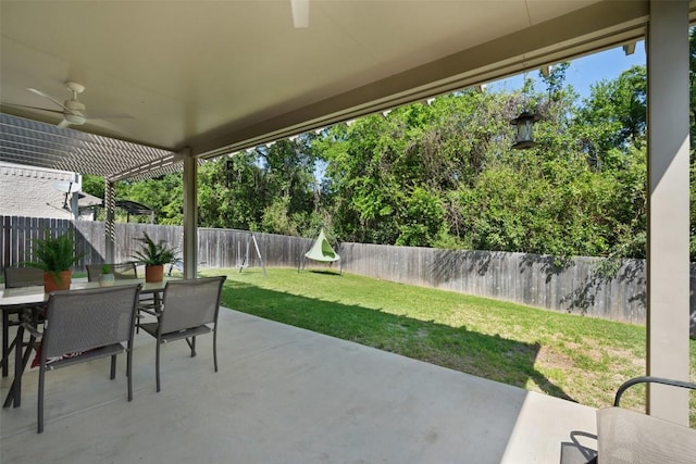 view of patio with outdoor dining area and a ceiling fan