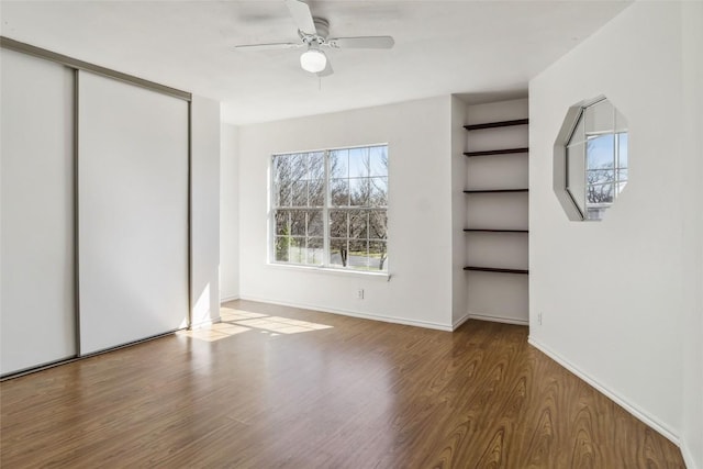 4320 Dos Cabezas Dr, Austin, TX 78749 - unfurnished bedroom with wood finished floors, ceiling fan, and a closet