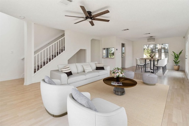 4320 Dos Cabezas Dr, Austin, TX 78749 - living area featuring light wood-style floors, stairway, ceiling fan, and baseboards
