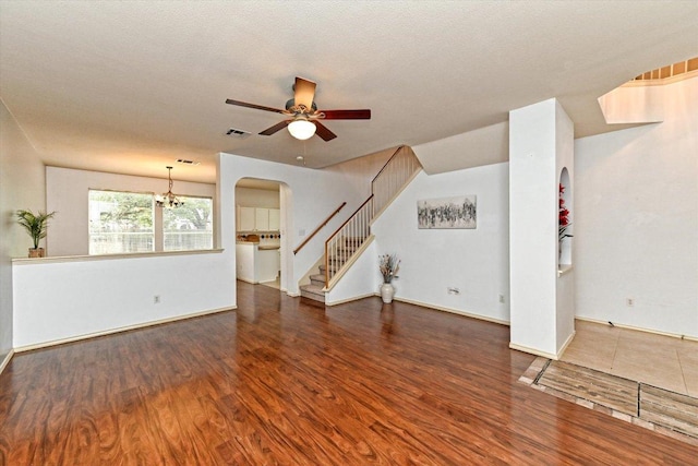 4437 Chickasaw Ct, Austin, TX 78749 - unfurnished living room featuring a ceiling fan, wood finished floors, stairs, and arched walkways