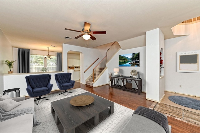 4437 Chickasaw Ct, Austin, TX 78749 - living area featuring arched walkways, wood finished floors, stairway, a chandelier, and a ceiling fan