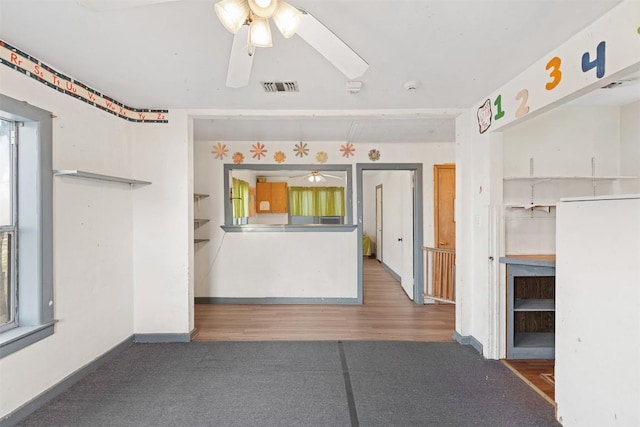 631 S Harris St, Giddings, TX 78942 - kitchen featuring visible vents, baseboards, a ceiling fan, and wood finished floors