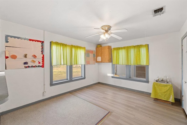 631 S Harris St, Giddings, TX 78942 - spare room with visible vents, baseboards, ceiling fan, and wood finished floors