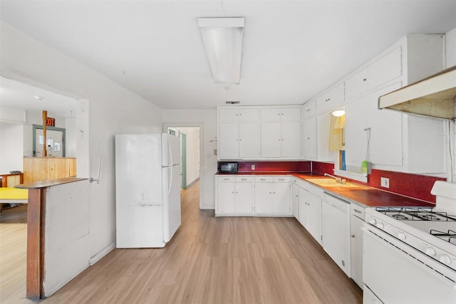 631 S Harris St, Giddings, TX 78942 - kitchen featuring light wood-style floors, white appliances, white cabinetry, wall chimney exhaust hood, and a sink