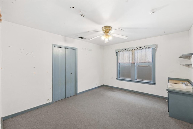 631 S Harris St, Giddings, TX 78942 - carpeted empty room with visible vents, baseboards, and a ceiling fan