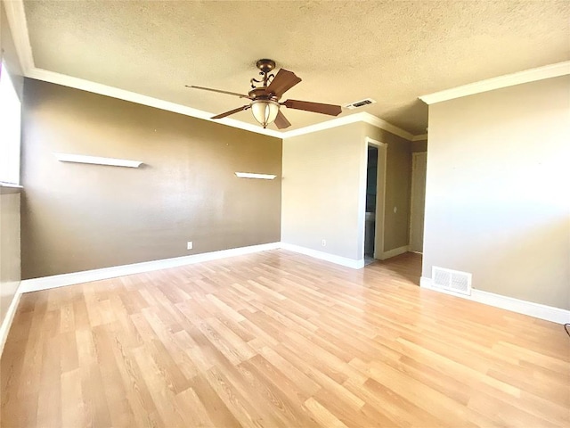8602 Colonial Dr, Austin, TX 78758 - spare room with a ceiling fan, light wood-style flooring, a textured ceiling, ornamental molding, and baseboards