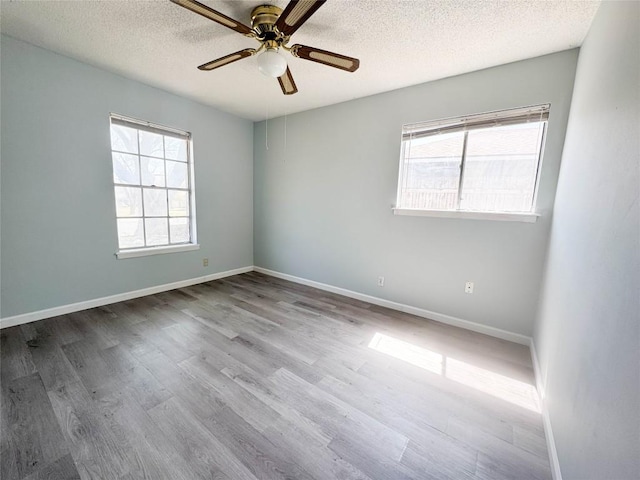 8602 Colonial Dr, Austin, TX 78758 - empty room with a textured ceiling, a ceiling fan, wood finished floors, and baseboards