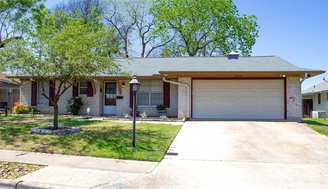 8602 Colonial Dr, Austin, TX 78758 - ranch-style house featuring brick siding, an attached garage, driveway, and a front lawn