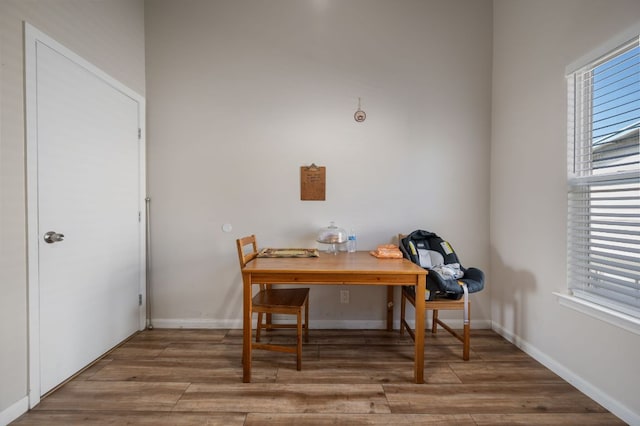 dining area featuring baseboards and wood finished floors