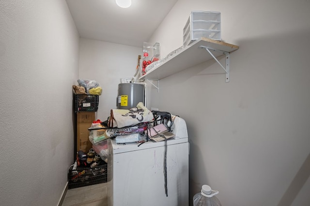 laundry room with washer and dryer, water heater, and laundry area