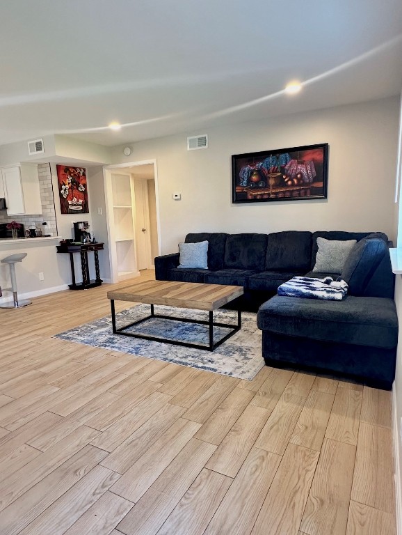 living room with visible vents and light wood finished floors