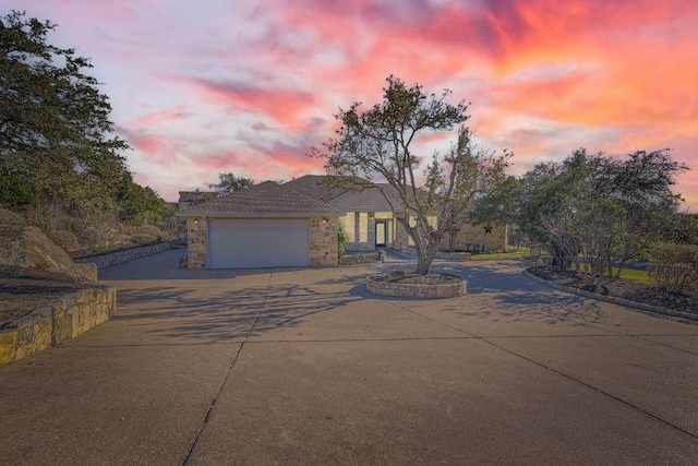 200 Hillside Dr, Dripping Springs, TX 78620 - view of front of house featuring concrete driveway, an attached garage, and stone siding