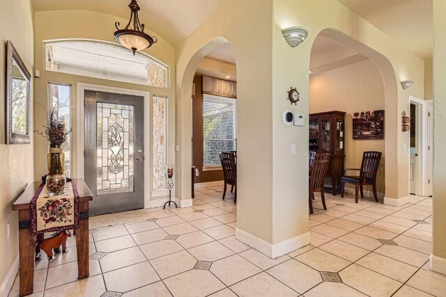 200 Hillside Dr, Dripping Springs, TX 78620 - foyer entrance with arched walkways, plenty of natural light, and light tile patterned floors