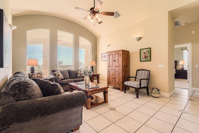 living area with light tile patterned flooring, ceiling fan, lofted ceiling, and a healthy amount of sunlight