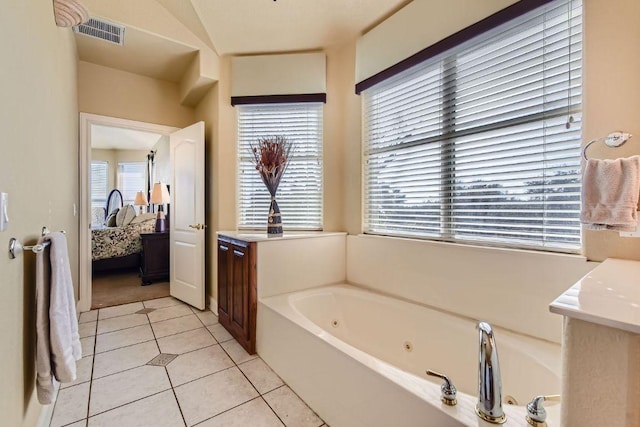200 Hillside Dr, Dripping Springs, TX 78620 - bathroom featuring ensuite bathroom, a jetted tub, and tile patterned flooring