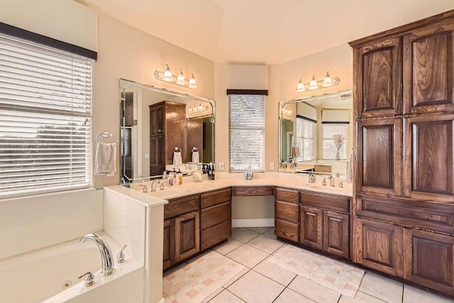 bathroom with vanity, a bath, and tile patterned floors