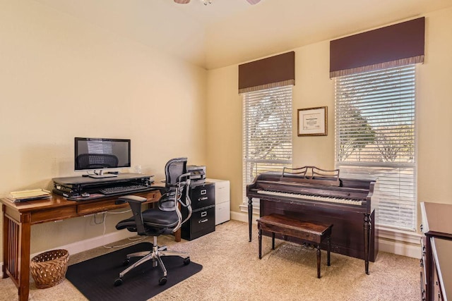 office featuring baseboards and light carpet