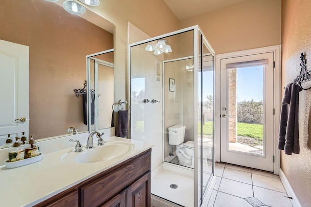 bathroom featuring a textured wall, vanity, and a shower stall