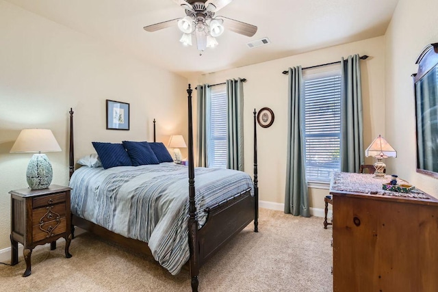 bedroom with visible vents, multiple windows, light carpet, and baseboards