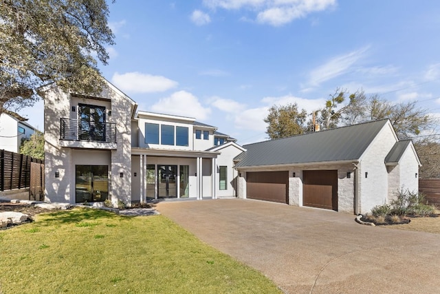 6102 Forest Hills Dr, Austin, TX 78746 - view of front of property with a balcony, stucco siding, driveway, a garage, and a metal roof
