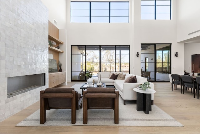 6102 Forest Hills Dr, Austin, TX 78746 - living room with a high ceiling, wood finished floors, and a fireplace