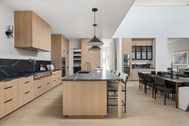 6102 Forest Hills Dr, Austin, TX 78746 - kitchen with light brown cabinetry, modern cabinets, appliances with stainless steel finishes, and recessed lighting