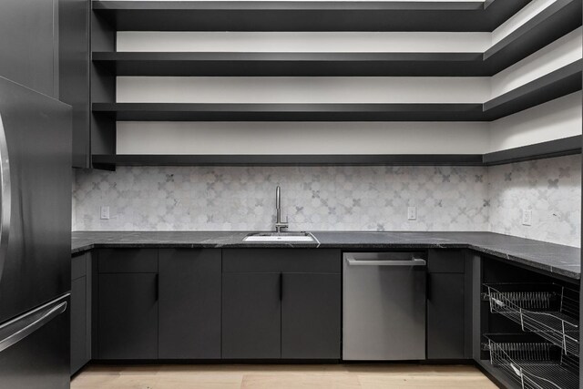 6102 Forest Hills Dr, Austin, TX 78746 - kitchen featuring open shelves, freestanding refrigerator, stainless steel dishwasher, light wood finished floors, and dark stone countertops