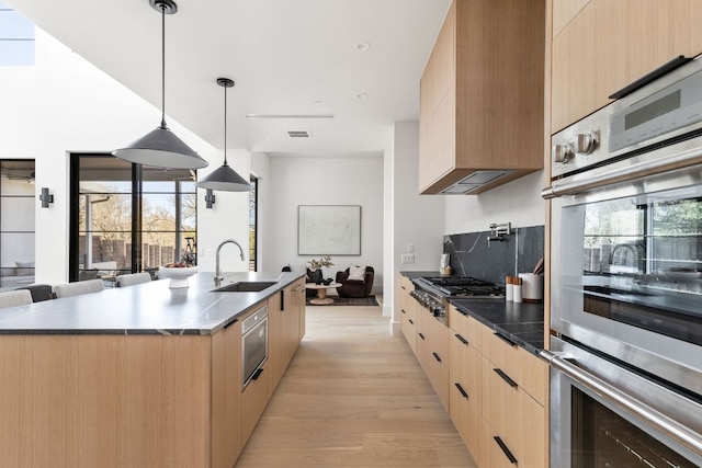6102 Forest Hills Dr, Austin, TX 78746 - kitchen with modern cabinets, open floor plan, light brown cabinets, and appliances with stainless steel finishes