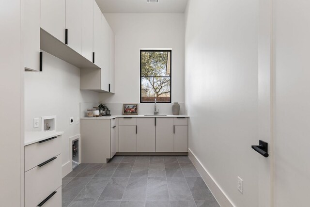 6102 Forest Hills Dr, Austin, TX 78746 - laundry room with hookup for an electric dryer and cabinet space