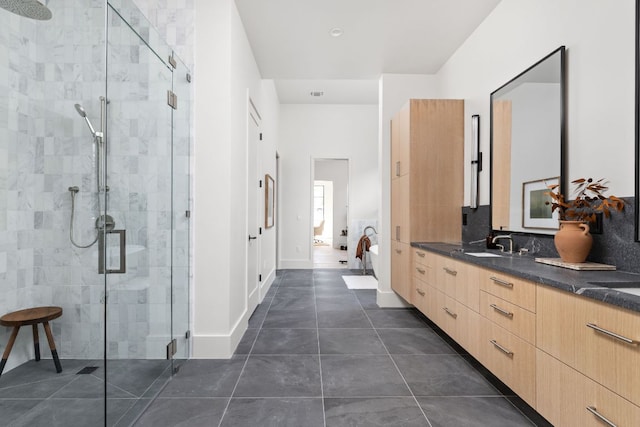6102 Forest Hills Dr, Austin, TX 78746 - bathroom featuring a stall shower, vanity, tile patterned floors, and tasteful backsplash