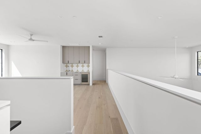 6102 Forest Hills Dr, Austin, TX 78746 - hallway featuring wine cooler and light wood-style floors