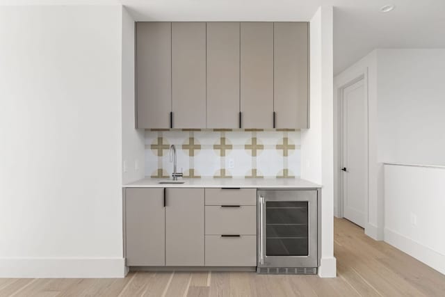6102 Forest Hills Dr, Austin, TX 78746 - indoor bar featuring wine cooler, light wood finished floors, and decorative backsplash