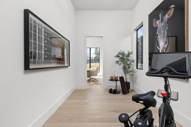 6102 Forest Hills Dr, Austin, TX 78746 - exercise room featuring wood finished floors and baseboards
