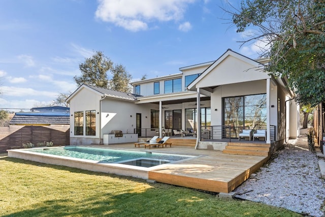 6102 Forest Hills Dr, Austin, TX 78746 - back of property with stucco siding, a standing seam roof, a wooden deck, ceiling fan, and a metal roof