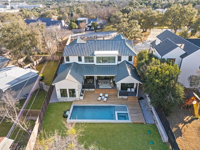 6102 Forest Hills Dr, Austin, TX 78746 - back of property with a standing seam roof, stucco siding, a metal roof, a fenced backyard, and a wooden deck