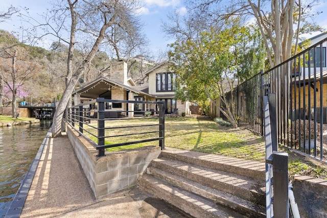 6702 Elfland Dr, Austin, TX 78746 - view of front facade featuring a water view and brick siding