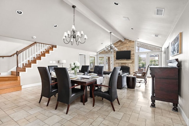 6702 Elfland Dr, Austin, TX 78746 - dining area featuring stone tile flooring, stairway, a fireplace, and a chandelier