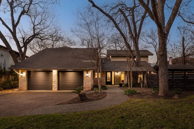 6702 Elfland Dr, Austin, TX 78746 - view of front of home with asphalt driveway, a garage, stone siding, and roof with shingles