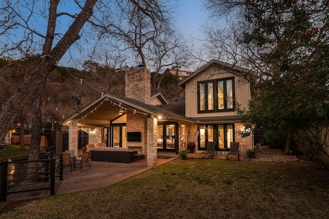6702 Elfland Dr, Austin, TX 78746 - rear view of house with an outdoor hangout area, stone siding, a chimney, and a patio area