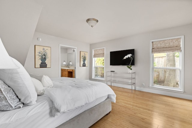 6702 Elfland Dr, Austin, TX 78746 - bedroom featuring wood finished floors and ensuite bathroom