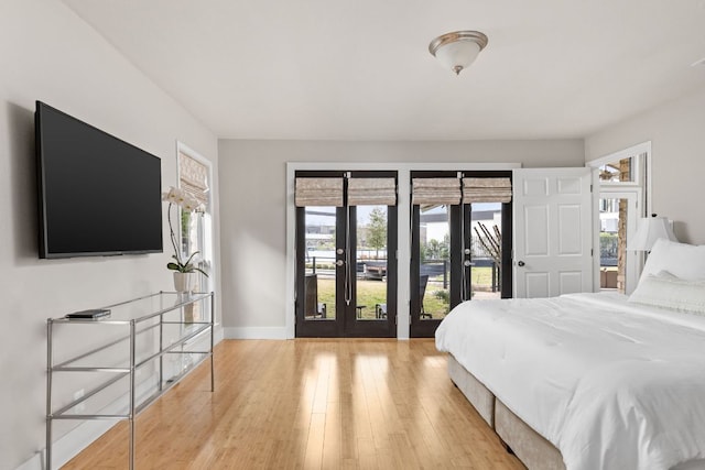 6702 Elfland Dr, Austin, TX 78746 - bedroom with french doors, access to exterior, and wood finished floors