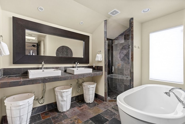 6702 Elfland Dr, Austin, TX 78746 - bathroom featuring a stall shower, a freestanding bath, stone tile flooring, lofted ceiling, and recessed lighting