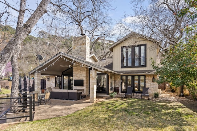 6702 Elfland Dr, Austin, TX 78746 - rear view of property with stone siding, an outdoor living space, a lawn, and a chimney