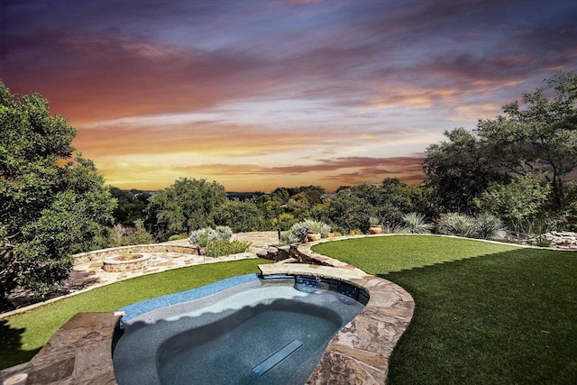 view of pool with an in ground hot tub and a yard