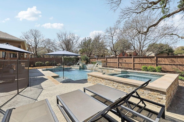 view of pool with a patio area, a fenced in pool, an in ground hot tub, and a fenced backyard